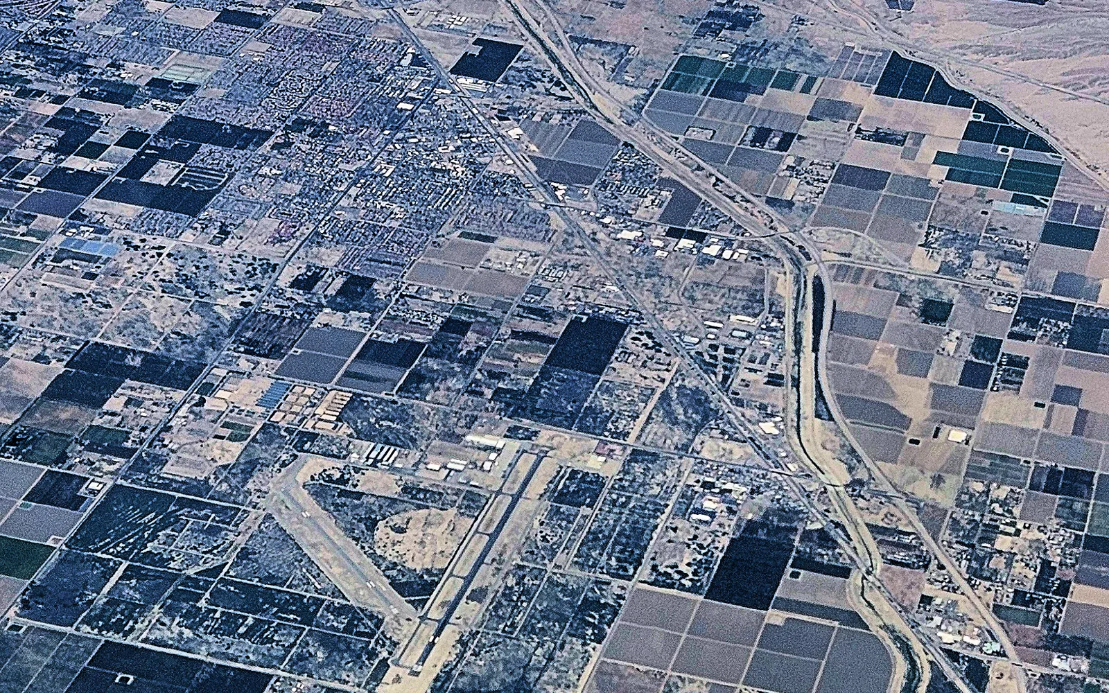 Aerial view of desert development and agricultural land in the Coachella Valley; regional context for La Quinta.